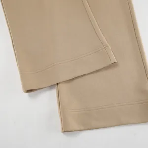 Detail view of khaki pants hem featuring high-quality fabric texture and precision stitching.