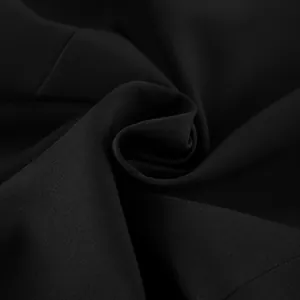 Macro detail of high-quality black suit fabric showing fine texture and soft drape