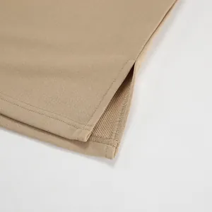 Close-up of side slit hem on a khaki oversized streetwear sweatshirt for women's fashion