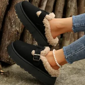 Close-up detail of black platform fur-lined mule shoes with rustic wooden background