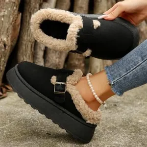 Detail view of black plush-lined platform mules with adjustable buckle strap.