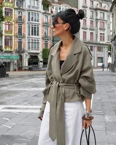 Chic sage green short trench coat featuring wide lapels and a tie-waist detail for fall