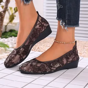 Detailed close-up view of brown floral lace mesh flats with a comfortable round toe