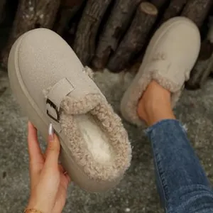 Close-up of warm beige furry mules with thick platform sole and soft faux fur lining