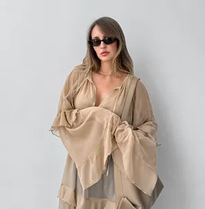 Close-up detail of a khaki sheer chiffon dress featuring ruffled batwing sleeves