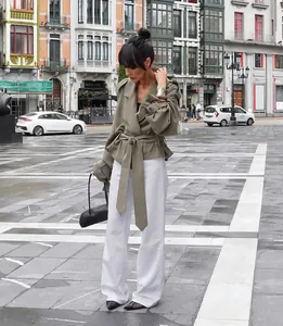 Elegant olive green belted trench coat with wide lapels for autumn street style