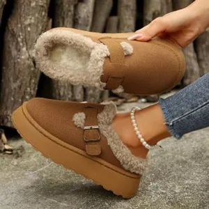 Close-up of brown suede fur-lined platform loafers with warm lining and buckle strap