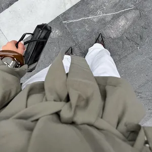 Top-down lifestyle view of stylish olive green belted trench coat for women