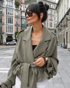 Model wearing a stylish khaki French lapel belted trench coat in an urban street setting