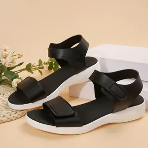 Side view of black women's wedge sandals with adjustable straps on a neutral background