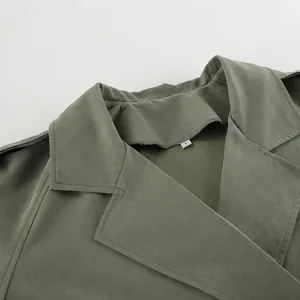 Detailed view of sage green French lapel trench coat collar showing fabric texture