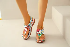 Vibrant macro detail of ethnic floral embroidered wedge thong sandals for women