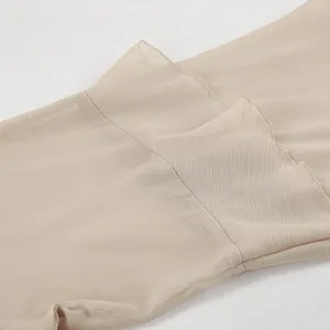 Detail view of khaki sheer chiffon fabric with elegant ruffle edge stitching and texture