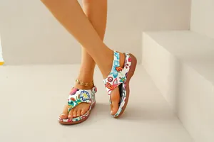 Detailed view of women's ethnic floral embroidered thong sandals with wedge heel