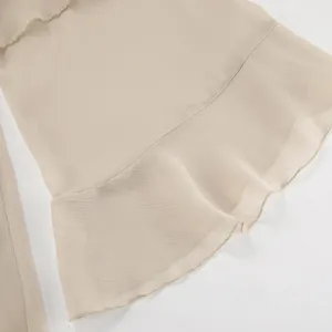 High-quality close-up detail of khaki chiffon dress featuring an elegant ruffled hemline