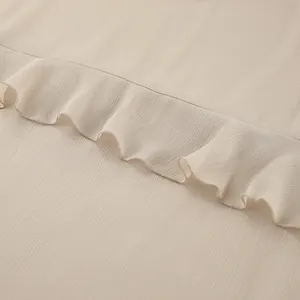 Detailed macro view of khaki chiffon dress fabric featuring delicate ruffle edge design