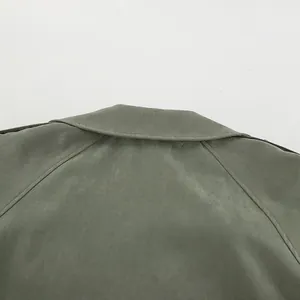Close-up detail of back collar on an olive green French style trench coat