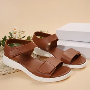 Side view of brown platform sandals with adjustable straps and white wavy soles