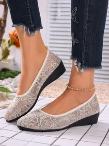 Elegant beige mesh loafers with floral lace embroidery and round toe shown on foot
