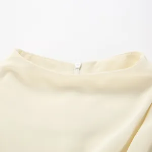 Detailed view of an elegant cream chiffon shirt neckline featuring a hidden zipper closure