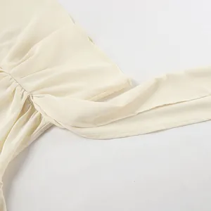 Detailed macro view of the pleated fabric texture on this elegant beige chiffon shirt