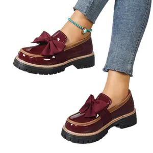 Burgundy patent leather loafers for women with oversized bow and thick lug soles