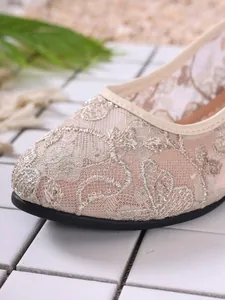 Detailed view of elegant champagne lace mesh flats with delicate sequin floral embroidery