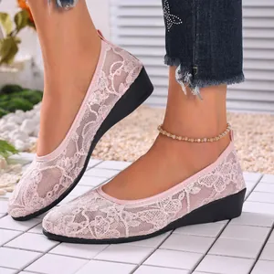 Close-up detail of pink floral lace mesh wedge shoes with a breathable summer design
