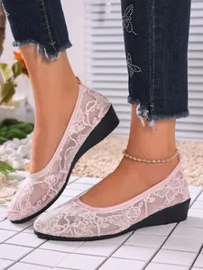 Detail showing pink floral lace mesh flats with comfortable wedge sole for women.