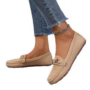 Casual women's beige loafers with pebble grain texture and gold metal buckle detail