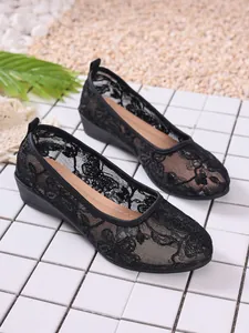 Detailed view of breathable black lace mesh flat shoes for women with round toe design