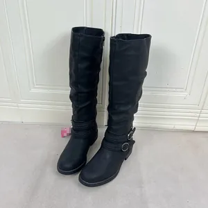 Elegant women's black slouchy knee-high boots featuring stylish buckle straps and round toe