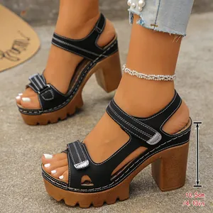 Side detail of black platform high heel sandals showing a 10.5cm heel height measurement