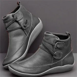 Stylish women's grey textured leather flat ankle boots featuring decorative side straps