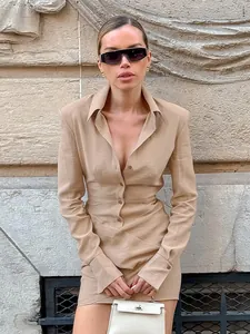 Elegant khaki long-sleeved mini dress with textured fabric and pleated waist design.