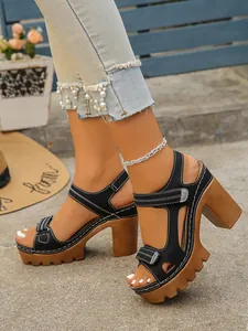 Side view of chic black platform high heel sandals with wood grain block heels.