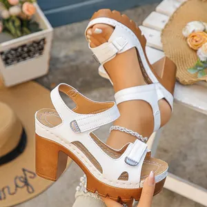 Detailed view of stylish white platform sandals featuring chunky heels and adjustable straps.