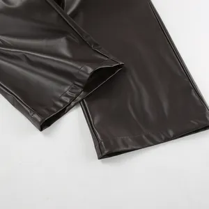 Détail du bas de pantalon en similicuir mat montrant l'ourlet et la texture lisse