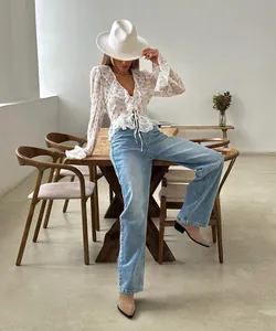 Detalle de una blusa de gasa con estampado floral, volantes y mangas acampanadas