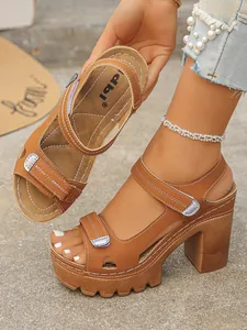 Brown platform high heel sandals showing adjustable straps and chunky sole detail