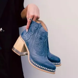 Stylish blue embroidered ankle boots with silver studs and acrylic crystal chunky heels.