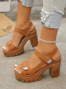 Detail of brown platform high heel sandals with block heel and velcro straps