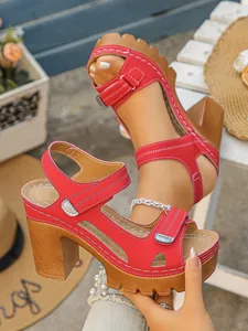 Red platform sandals with chunky wood-texture high heels and velcro straps