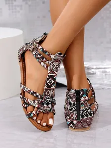 Detail view of colorful bohemian Roman flat sandals with tribal patterns and a back zipper