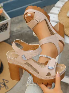 Stylish beige women's high-heeled platform sandals with chunky heels and ankle straps.