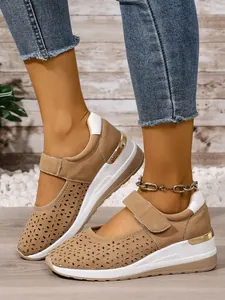 Detailed macro view of women's hollow-out breathable khaki wedge sneakers with velcro strap