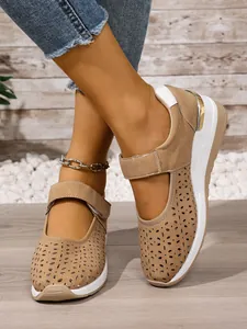 Detail of khaki breathable hollow-out wedge sneakers featuring hook and loop strap