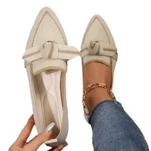 Beige flyknit pointed-toe flats with stylish bow detail and comfortable slip-on design