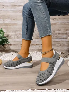 Detail showing grey breathable perforated wedge sneakers with adjustable velcro strap