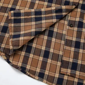 Detail of coffee plaid shirt fabric showing texture and black buttons